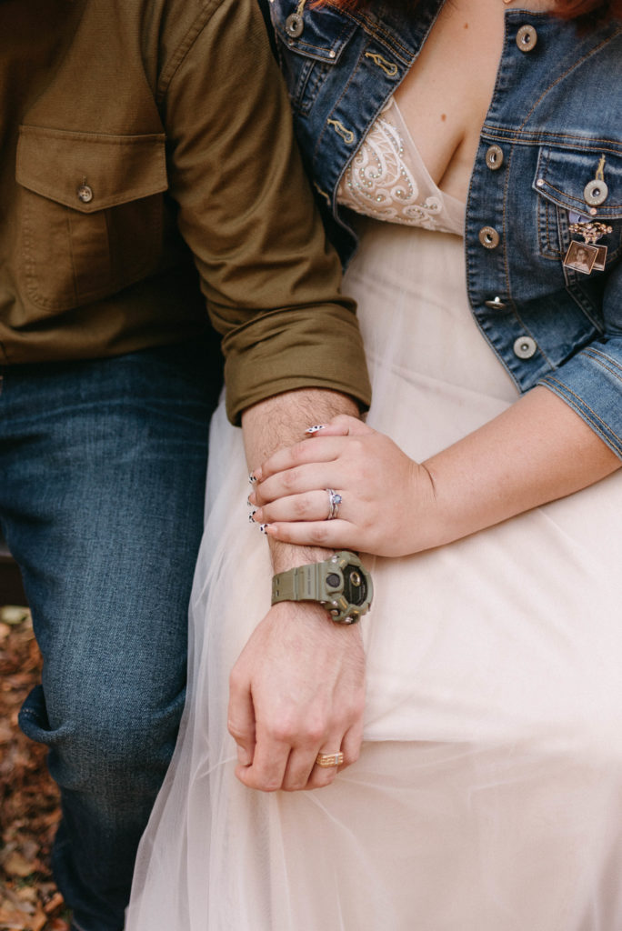 couples hands intertwined with their wedding rings