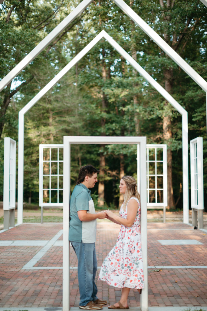 a man and woman hold hands in a door frame. virginia wedding venue