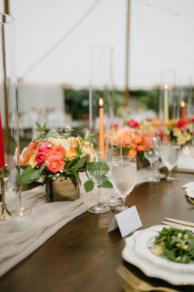 centerpieces and candles on a reception table 