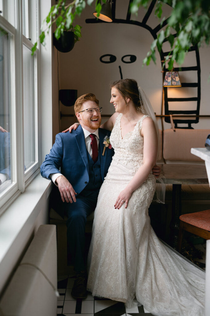 A bride sitting on her grooms lap. 