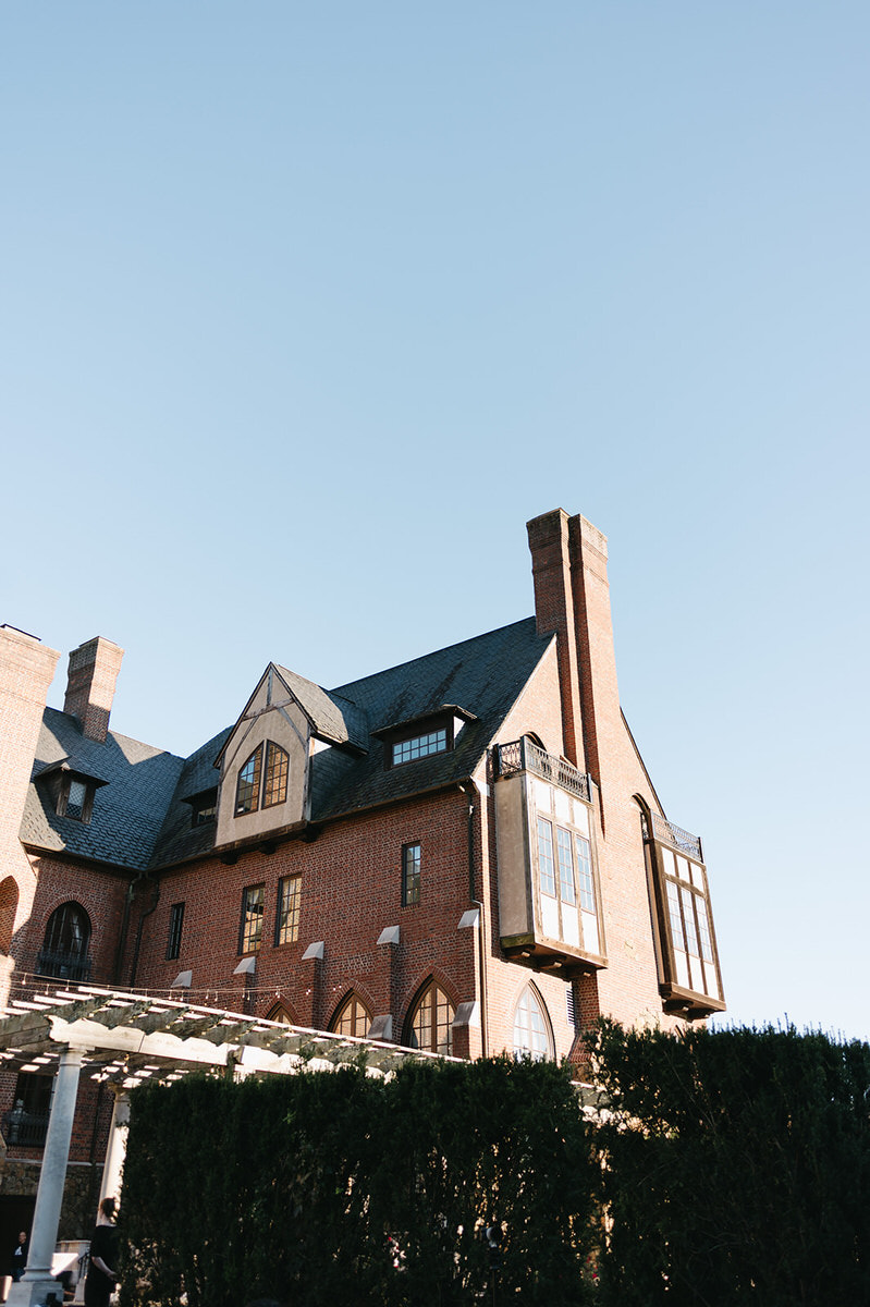 The imposing facade of Dover Hall under clear blue skies, focusing on the architectural beauty and design of this historic wedding venue.