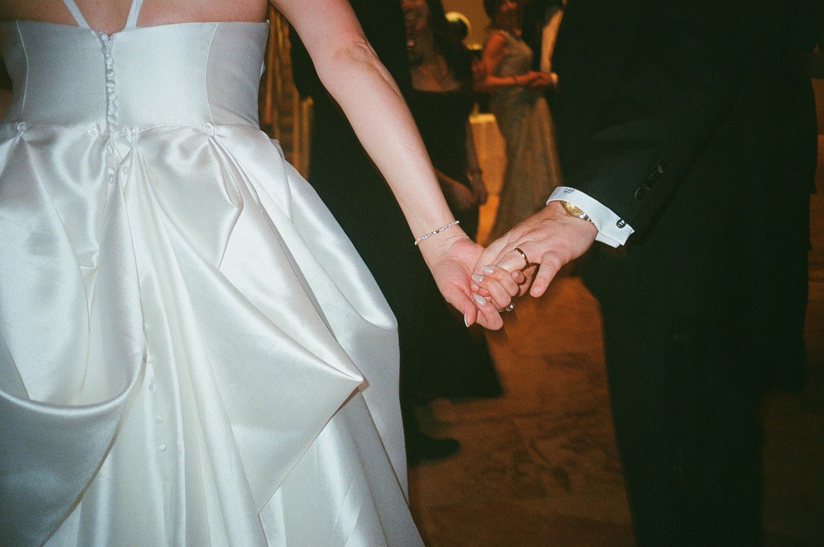 A close up of newlyweds holding hands at one of the best luxury wedding venues in Virginia.