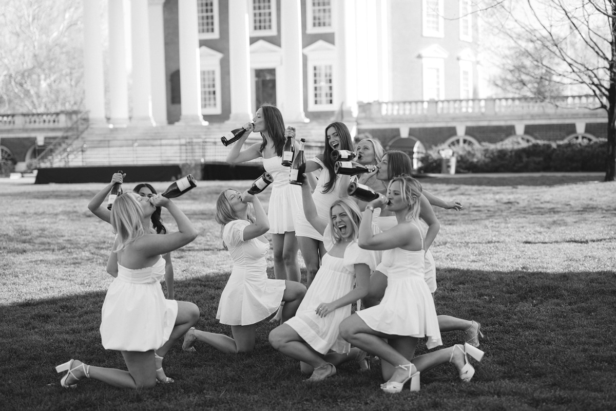 Girls drinking champagne and posing for their UVA graduation photos