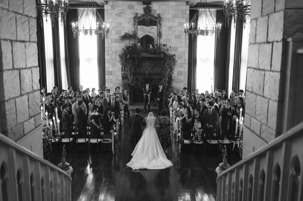 A person walking down the aisle with their parents at their wedding. 