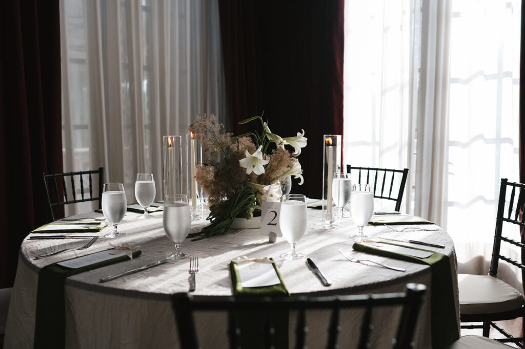 A round wedding reception table with a floral arrangement in the middle 