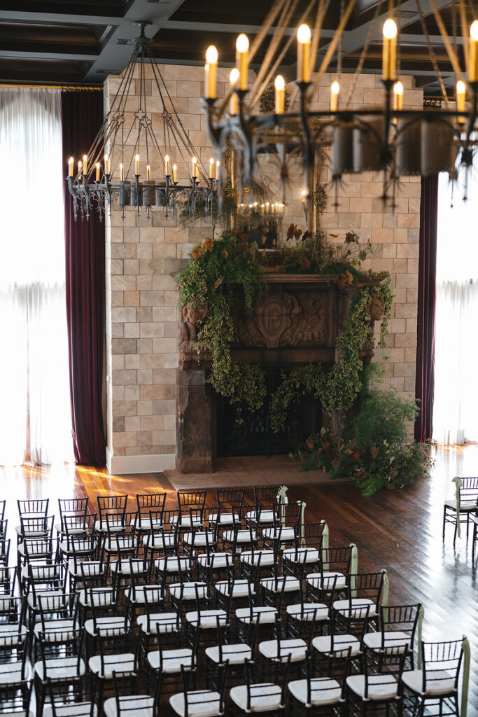 Rows of chairs set up in a large wedding venue 