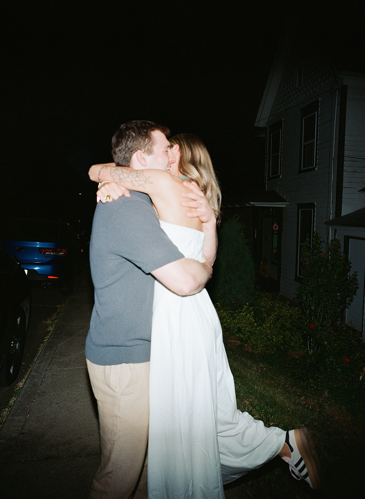 A couple embracing on the sidewalk